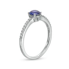 A simple look with vibrant color, this fashion ring suits her minimalist style. Crafted in sterling silver, this design showcases a 5.0mm bright blue lab-created sapphire at the center. Petite white lab-created sapphires glisten along the shank for a subtle touch of shimmer. Buffed to a brilliant luster, this ring is a lovely addition to her jewelry box. Modern Sapphire Prong Setting Promise Ring, Modern Tanzanite Round Rings, Modern Blue Sapphire Promise Ring, Classic Tanzanite Promise Ring, Modern Birthstone Ring With Prong Setting For Promise, Elegant Round Cut Blue Stackable Rings, Modern Promise Ring With Prong-set Birthstone, Modern Sapphire Ring With Brilliant Cut For Promise, Modern Brilliant Cut Sapphire Promise Ring