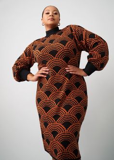 Style#: 7009/P7009 Rock the Zania Sweater Dress in Black Amber Dots this fall and winter season. This knit-fitted, mock neck, dress makes a statement with a bold African-inspired print and balloon Blouson sleeves. Features: Contrast colored ribbed knit at mock neck, extended cuff 45% Cotton/55% Acrylic Designed in the USA, imported Length Range: 42"-44" Designed in the USA, imported Care Instructions: Hand wash cold. Do not soak. Do not bleach. Lay flat to dry. Models: Size: XL Height 5'9" | Bus Sweater Dress Black, Mock Neck Dress, Print Sweater, Mens Fall, African Inspired, Printed Sweater, Swimwear Accessories, Womens Fall, Fall And Winter