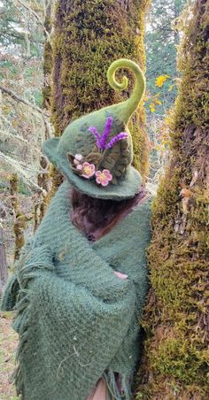 This hand-sculpted hat is made using almost 1lb of sheep's wool, making it extremely durable and able to hold its shape well, perfect for woodland walks.  Inspired by the blossoms of the apple trees growing wild on our land, it features three sprigs of lavender and three apple blossom flowers. We make our felted items using the ancient technique of wet felting. The process begins with raw sheep wool, which we buy locally from small family farms. We then wash dye and card the wool into batts, ready to sculpt and felt into whatever our imaginations dream up. Felted wool is considered to be among the world's oldest known textiles. It is both breathable and water-resistant, able to hold up to 40% of its own weight in water before it begins to feel wet. This makes it an excellent choice for bot Wool Felted Witch Hat, Whimsical Handmade Felt Hat, Whimsical Handmade Fall Hats, Whimsical Handmade Felt Costume Hats And Headpieces, Handmade Whimsical Felt Hat, Handmade Whimsical Felt Hat For Winter, Whimsical Felt Hat With Curved Brim, Whimsical Handmade Wide Brim Felt Hat, Whimsical Wide Brim Handmade Felt Hat