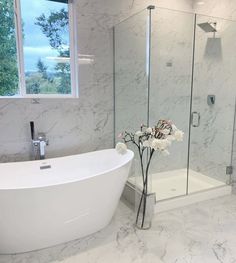 a white bath tub sitting next to a window