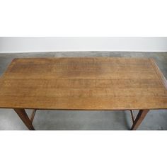 a wooden table sitting on top of a cement floor