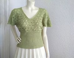 70s-80s knitted blouse, butterfly sleeve, see through, boho blouse, mesh top, V-neck summer lace blouse, very high waist, chartreuse green blouse, retro lurex shiny top, discreet shiny lurex fabric, dolman sleeve. no label size, no label composition, probably soft acryl fabric. very good vintage condition, the blouse is not washed. measurements laying flat : shoulders and both sleeves together :82 cm (32,5 inches) bust: 48 cm (19 inches) total lenght:55 cm (21,5 inches) Vintage Stretch V-neck Top, Fitted V-neck Crochet Top With Pointelle Knit, Green V-neck Knit Top For Summer, Green Open Knit Top For Summer, Fitted Green V-neck Knit Top, Green Fitted V-neck Knit Top, Fitted Knit Top With Lace Detail, Fitted Green Crochet Top For Spring, Green V-neck Stretch Knit Top