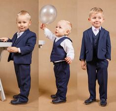 two young boys dressed in suits and holding a balloon