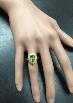 3.20 Carats Natural Very Nice Looking Peridot and Diamond 14K Solid Yellow Gold Ring Suggested Replacement Value: $5,300.00 Total Natural Pear Shaped Peridot Weight is: Approx. 2.50 Carats Peridot Measures: Approx. 11 x 7mm Natural Round Diamonds Weight: Approx. 0.70 Carats (color G-H / Clarity SI1-SI2) Ring total weight: 4.9 grams Ring total weight: Approx. 1.6 grams Disclaimer: all weights, measurements and colors are approximate and may vary slightly from the listed dimensions or as seen in t Formal Peridot Diamond Ring In Yellow Gold, Luxury Peridot Rings With Accent Stones, Luxury Multi-stone Peridot Ring, Luxury Peridot Multi-stone Rings, Green Multi-stone Diamond Ring For Formal Occasions, Formal Green Multi-stone Diamond Ring, Classic Multi-stone Green Gemstones, Classic Green Multi-stone Gemstones, Elegant Green Gemstones In 14k Gold