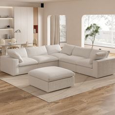 a living room with white furniture and wooden floors