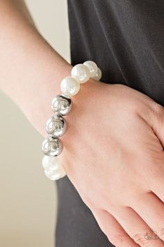 Gradually increasing in size near the center, oversized pearly white and shiny silver beads are threaded along a stretchy band around the wrist for a glamorous finish. Sold as one individual bracelet. Silver Pearl Bracelet, Paparazzi Accessories Jewelry, White Pearl Bracelet, White Bracelet, White Bracelets, Paparazzi Accessories, White Rhinestone, Stretchy Bracelets, Paparazzi Jewelry