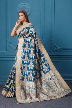 Look royal at weddings and festive occasions in this beautiful sea blue Banarasi silk saree with zari minakari work, It comes with a blouse piece. Disclaimer: The shown stitched blouse on the model is for display purpose only. The saree comes with a matching blouse piece and finished with fall and piko. Blue Dola Silk Saree With Traditional Drape, Blue Dola Silk Saree In Traditional Drape, Blue Katan Silk Saree For Eid, Eid Blue Katan Silk Saree, Blue Semi-stitched Dola Silk Saree, Blue Dola Silk Saree With Zari Work, Blue Katan Silk Blouse Piece, Blue Banarasi Silk Saree For Eid, Blue Katan Silk Blouse Piece With Zari Weaving