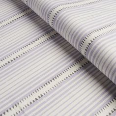 a purple and white striped wallpaper