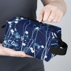 "This unique and stylish Cyanotype bag would be the perfect partner for artists and crafters. The Cyanotype Sisters bag is eye-catching, highly durable, and water-resistant. It's great for keeping your bookmaking or art supplies safe and organized, regardless of the environment. The bag is also easy to clean, thanks to its non-woven black laminated liner.  100% polyester broadcloth One size: 7.5\" x 4\" x 3.8\" (19.05cm x 10.16cm x 9.65cm) Non-woven black laminated polyester liner Black zipper, polyester carrying strap, and tabs Water-resistant All-over print" Artistic Rectangular Pouch For Everyday Use, Practical Rectangular Bag With Zipper Pouch, Practical Rectangular Zipper Pouch Bag, Modern Blue Cosmetic Bag For Everyday Use, Practical Rectangular Gift Bag, Functional Blue Bag For Gift, Modern Rectangular School Pouch, Cyanotype Bag, Travel Cases