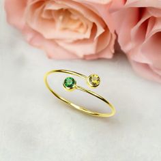 This dainty open ring features two sparkly gemstones. Minimal and on-trend, it is perfect to wear alone or stack with other delicate rings. Metal: 925 sterling silver; optional 18k yellow gold vermeil Gemstones: ruby, emerald, sapphire, amethyst, citrine (0.12 ctw) The ring is adjustable, fits on any finger and can be squeezed softly to make comfortable when worn Hypoallergenic: nickel-free materials used therefore suitable for those with metal allergies Emerald Ring Design, Emerald Stone Rings, Two Stone Ring, Emerald Ring Gold, Fine Ring, Ruby Emerald, Ring Ideas, Citrine Ring, Citrine Gemstone