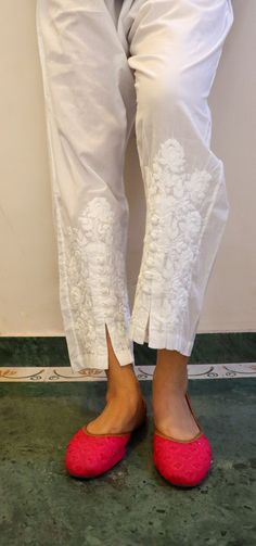 Relaxed Fit Cotton Pants with opening and button inserts. Embroidered in chikankari by skilled artisans. Length - 38/39 inches Size -  S -  waist stretched fits upto 40 M - waist stretched fits upto 42 L -  waist stretched fits upto 44 XL - waist stretched fits upto 46 XXL - waist stretched fits upto 48/50 Traditional Embroidered Ankle-length Bottoms, Traditional White Bottoms, Traditional White Long Pants, Traditional Cotton Straight Leg Bottoms, Traditional Straight Leg Cotton Bottoms, Traditional Cotton Bottoms With Floral Embroidery, Traditional White Trousers, White Cotton Pants With Floral Embroidery, Traditional White Bottoms With Floral Embroidery