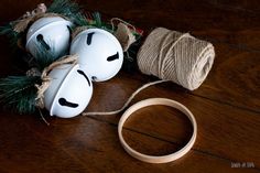 two white masks sitting on top of a wooden table next to twine and rope