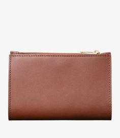 A.P.C. Women's coin purse. - Smooth calfskin leather.- Rounded corners.- Vegetable tanning, will develop a natural patina.- Eight-position cardholder, four on right and four on left.- One banknote pocket.- Snap button closure.- Zipped pocket.- Goldtone 'A.P.C. rue Madame' logo embossed on front. Topstitched edges. Classic Brown Business Coin Purse, Brown Bifold Coin Purse For Business, Brown Trifold Coin Purse With Rfid Blocking, Brown Trifold Coin Purse With Card Slots, Rectangular Cognac Wallets With Coin Pocket, Luxury Brown Coin Purse With Coin Pocket, Trifold Brown Coin Purse With Card Slots, Rectangular Cognac Wallet With Coin Pocket, Leather Trifold Coin Purse With Card Slots