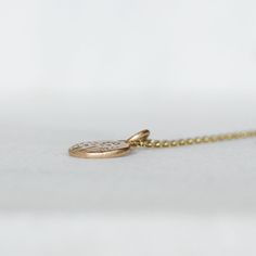 Sweet diamond and gold wildflower necklace. I melted and hammered 2 grams of 14k yellow Gold into an organically shaped disc. I set sparkly white diamonds into the center of wildflowers hand drawn with chasing tools. Hangs from a delicate 1.3mm cable chain with a spring clasp. Pebble - about 10mm x 11mm's, and roughly 2mm's thick Diamonds - 1.7mm Si1 White Diamonds - Conflict-Free Because each pendant is made by hand, no two will be exactly the same. That being said, I am a perfectionist when it Hammered 14k Gold Wedding Necklace, Wedding Hammered 14k Gold Necklaces, 14k Gold Hammered Necklace For Wedding, Heirloom Yellow Gold Jewelry With Birth Flower, Heirloom Yellow Gold Birth Flower Jewelry, Delicate Yellow Gold Brass Charm Necklaces, Delicate Yellow Gold Brass Charm Necklace, Hammered Yellow Gold Nature-inspired Jewelry, Delicate Engraved Yellow Gold Jewelry