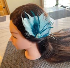 Fascinator Feather clip  Beautiful feather clip using different goose feathers and peacock fringe in teal blue and aqua colors. A beautiful metal pearl rhinestone embellishment is added in the center. It is attached to an alligator clip on the back. it measures approx 4" wide by 4" tall. Custom orders are accepted and can be made in any colors needed. Great for weddings, photo props, and other special occasions. This listing is for 1 piece but I can make as many as needed.  Combined shipping is available. feel free to ask any questions. Turnaround time is approx 1-3 days.  Note: I custom make all of my items, and I will be posting lots of listings for bridal, baby and special occasions. I had an Etsy store a few years ago and my items are high quality.  I'm not a new seller but due to fami Clip Wedding Hair, Hair Clip Wedding, Teal Hair, Feather Fascinator, Bridal Hair Clip, Feather Fascinators, Goose Feathers, Blue Feather, Aqua Color