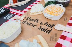 a table topped with lots of different types of food on top of a checkered table cloth