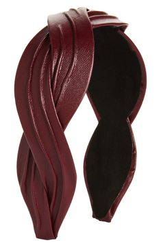 a red leather headband with an open knot on the top and one end in black