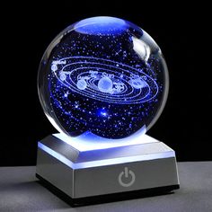 a glass ball with an image of the planets in it on top of a stand