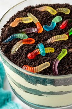 a close up of a cake with worms on top and dirt in the middle,