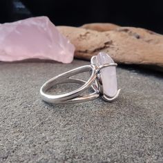 Bring warmth and love into your life with this beautiful Rose Quartz Ring featuring a tumbled stone in a prong setting in Sterling Silver. The ring fits the majority fingers being a Size 7. A stone of unconditional love and infinite peace, Rose Quartz encourages self-love, self-worth, self-trust, and self-acceptance. Wearing this ring helps to open your heart chakra and bring deep inner healing, calm, and trust. FEATURES: • tumbled rose quartz stone - 15mm wide by 18mm long • sterling silver rin Rose Quartz Crystal Ring For Promise, Promise Ring With Rose Quartz And Gemstone Detail, Silver Rose Quartz Crystal Ring, Lotus Moon, Peace Ring, Peace Rose, Double Terminated Crystal, Blue Opal Ring, Raw Quartz Crystal