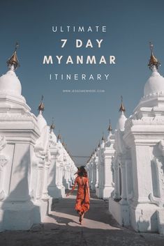 a woman in an orange dress is walking through white buildings with the words ultimate 7 day myanmar itinerary