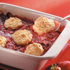 a casserole dish filled with meatballs and crumbled cheese on top