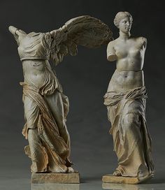 two statues of women standing next to each other