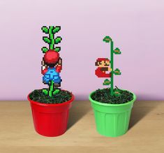 two potted plants that have been made to look like mario and luigi bros characters