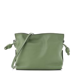 This is an authentic LOEWE Calfskin Mini Flamenco Knot Bag in Avocado.This chic and lovely tote is crafted of luxuriously soft calfskin leather in green. This shoulder bag features green leather cinch cords, an optional shoulder strap, and gold hardware. The top opens to a brown suede fabric interior. Green Leather-lined Tote Shoulder Bag, Modern Green Shoulder Bag With Smooth Grain, Luxury Green Bag With Smooth Grain, Green Textured Leather Evening Bag, Luxury Green Pouch Shoulder Bag, Luxury Green Bag With Rolled Handles, Luxury Green Bags With Rolled Handles, Green Shoulder Bag With Rolled Handles For Travel, Designer Green Leather Bags