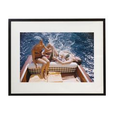 two nude women lounging on the back of a boat