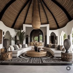 a living room filled with lots of furniture under a large wooden roof covered in wicker