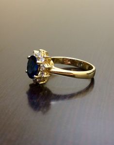 DeKara Designs Collection Metal- 14K Yellow Gold, .583. Stones- 1 Oval Blue Sapphire 1.14 Carats, 10 Round Diamonds G-H Color VS2 Clarity, 0.30 Carats. Size- Ring is a 5 3/4, and could be sized up or down at no additional cost! Handmade 14K Yellow Gold Sapphire and Diamond Ring. This ring is inspired by the Art Deco era with an enticing fiery oval shaped blue sapphire. The sapphire is set in between 4 prongs. The sapphire has a halo of prong set 10 round diamonds surrounding them which brings ou Sapphire Diamond Engagement Ring, Diamond Sapphire Engagement Ring, Sapphire Diamond Engagement, Blue Sapphire Diamond, Gold Halo, Diamond Wedding Ring, Halo Diamond Ring, Sapphire Diamond, Halo Diamond