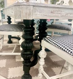 a table and chairs with black and white checkered cushions