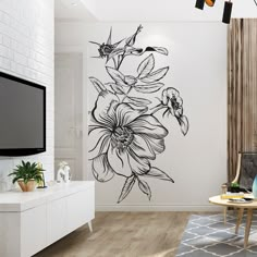 a living room with a large flower decal on the wall and a television in the corner