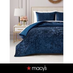 a blue comforter set with white pillows