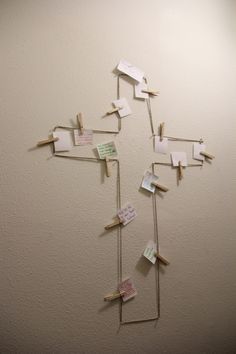 a group of clothes pins attached to a wall with post - it notes on them