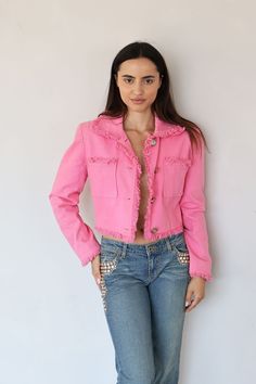 Gorgeous vintage UNGARO denim jacket in hot pink. Jacket features big front pockets, chunky silver coin buttons, and a frayed trim with subtle shoulder padding. In very good condition. Light sun fading to shoulders. Measurements: bust: 38" waist: 30" shoulder to shoulder: 18" length: 20" label: EMANUEL by Emanuel Ungaro size: Marked FR40; best fits XS-M Model is 5'6 and 34b-25-35 All of my items are all vintage. I strive for the best quality and condition possible, and to accurately describe con Pink Button-up Denim Jacket, Pink Denim Jacket With Button Closure For Spring, Pink Denim Jacket For Spring With Button Closure, Spring Pink Denim Jacket With Button Closure, Trendy Fitted Pink Denim Jacket, Pink Outerwear With Buttoned Pockets For Spring, Trendy Pink Cropped Jacket With Pockets, Chic Pink Outerwear With Snap Buttons, Hot Pink Denim