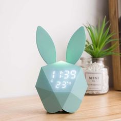 the alarm clock is designed to look like a rabbit's head with ears on it