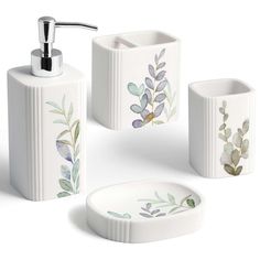 four pieces of bathroom accessories including soap dispenser and toothbrush holder