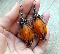 These burnt orange dangle (drop) floral earrings are made of polymer clay and copper. Statement and unique piece of jewelry in warm autumn colors can be a part of your fashion not only this fall, but all over the year. Tender and bright pods will emphasize the individuality of their owner. The earrings can be a beautiful gift for your beloved woman to make her happy. Earring length is about 1.57 inches. Can be made in different colors and sizes. Perfect match to the pendant: https://www.etsy.com Artisan Orange Copper Earrings, Handmade Artisan Orange Earrings, Handmade Orange Dangle Flower Earrings, Orange Dangle Polymer Clay Earrings, Orange Dangle Earrings Polymer Clay, Orange Dangle Earrings In Polymer Clay, Orange Dangle Resin Earrings, Orange Polymer Clay Dangle Earrings, Orange Resin Dangle Earrings