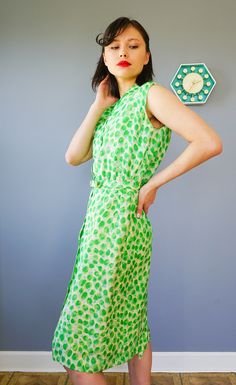 "DESCRIPTION * vintage dress from 1950s by Adele Martin * made with pure silk, in abstract green print * sheath dress style: form-fitting, a straight cut, and the waistline is slightly nipped, accentuating the long slim silhouette. * shirt collar, sleeveless * button down to the hip area * comes with matching belt * beige lining skirt * tag reads \"Adele Martin/ WPL 7588, 100% Pure Silk, Exclusive of Ornamentation, lining and trimming, Dry Clean Only/ Size 12/ Union Label ABFY 160866\" CONDITION Green Silk Midi Dress For Daywear, 1950s Style Sleeveless Green Dress, Green Fitted Sleeveless Vintage Dress, Green Sleeveless Retro Vintage Dress, Vintage Green Midi Length Dress, Fitted Retro Green Midi Dress, Mid-century Green Summer Dress, 1950s Style Green Daywear Dresses, 1950s Style Green Vintage Dress For Spring