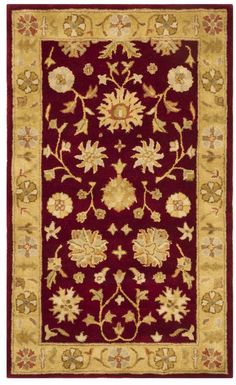 a red and gold rug with flowers on the bottom, in front of a white background