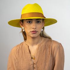 Complete your look with a stylish Ortus hat.  The Sol hat is wonderfully crafted in a striking classic weave pattern, blending rich hues of yellow straw. It is dressed up with a camel grosgrain ribbon.  The Sol hat is a stylish accessory and its brim is great for protecting wearers in the sun. This hat is perfect for the beach or walking around the city, and can be worn by women and men.  Ortus hats are contemporary and are made with bold design concepts.  The hats are individually dyed and hand Luxury Fedora Straw Hat For Kentucky Derby, Luxury Wide Brim Panama Hat For Spring, Luxury Panama Hat With Curved Brim For Spring, Yellow Wide Brim Straw Hat In Toquilla Straw, Yellow Wide Brim Toquilla Straw Hat, Luxury Toquilla Straw Hat, Luxury Panama Hat With Short Brim For Spring, Elegant Yellow Straw Hat For The Beach, Elegant Yellow Straw Hat For Beach