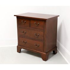 a wooden dresser with three drawers on one side and two pulls on the other end