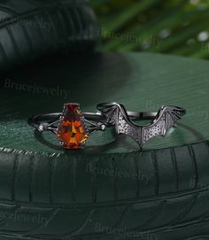 an orange stone ring sitting on top of a green surface