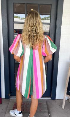 Add a pop of color to your wardrobe with The Lexa Dress! This playful mini dress features a multicolor striped pattern and bubble sleeves. With a convenient pocket at the sides and a button closure at the back, it's both stylish and functional. The elastic cuffs and lightweight fabric make it perfect for any occasion. Get ready to turn heads in this fun and vibrant dress! Lilli is wearing a size Small. Height is 5’3, Bust is 32”, Waist 26”, and Hips 33”. Vibrant Dress, Vintage Havana, Top Graphic Tees, Sweater Set, New Arrival Dress, Mens Outerwear, Dress Romper, Mens Graphic Tee, Vintage Shoes