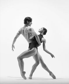 two dancers in black and white pose for the camera