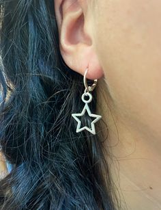 Our simple, affordable silver star earrings are the perfect accessory for any outfit. Add a little edge to your look! These earrings are great for casual wear or for dressing up your makeup on the weekend. Pair them with any outfit from jeans to a cocktail dress. They're cute, dainty and easy to wear - just add these to your cart today! Lever back to secure, these 'huggie' earrings are the perfect gift for someone or for yourself! * Listing is for one (1) pair of star earrings. Processing + Ship Star Earrings Y2k, Silver Star Earrings Dangle, Cute Star Earrings, Silver Earrings Hoop, Simple Earrings Silver, Star Earrings Aesthetic, Earings Aesthetics, Cool Earrings Aesthetic, Cool Earrings Unique