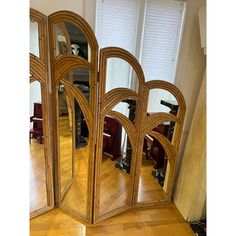 a room divider made out of wood with mirrors on the top and bottom half