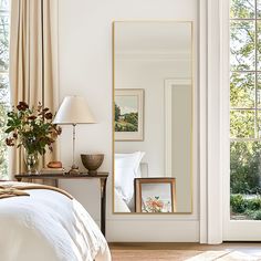 a bedroom with a large mirror on the wall